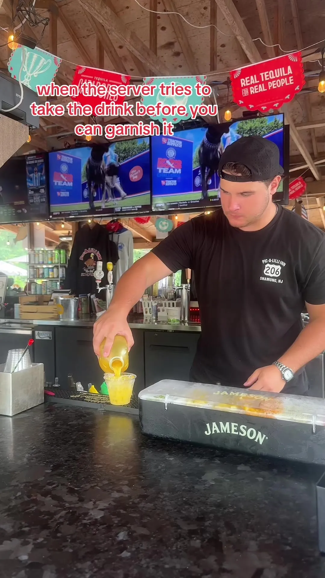 Bartender pouring a cocktail at the Pic-A-Lilli patio bar